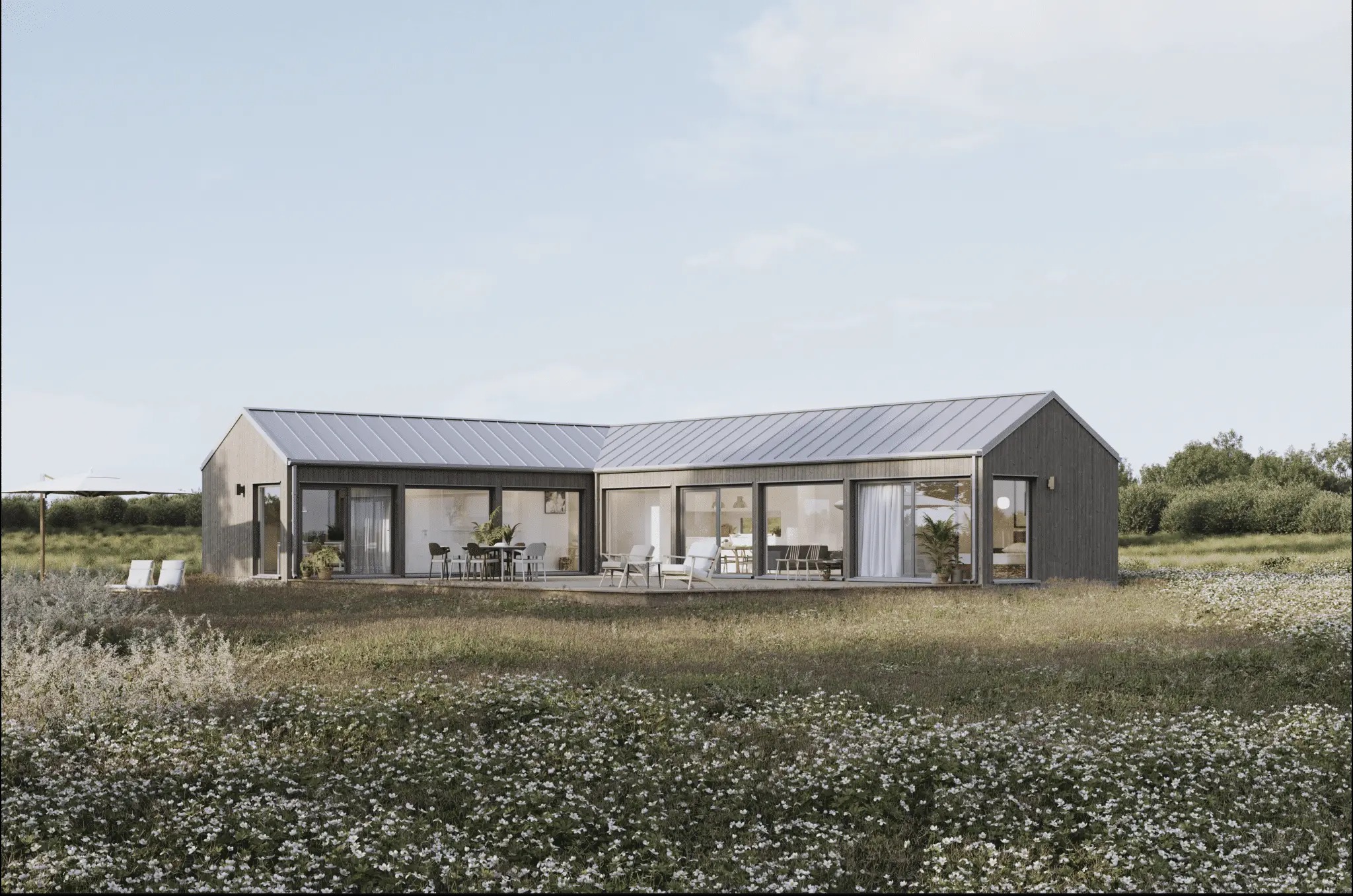 Modern house with black frame and glass walls in a field with white flowers and grass
