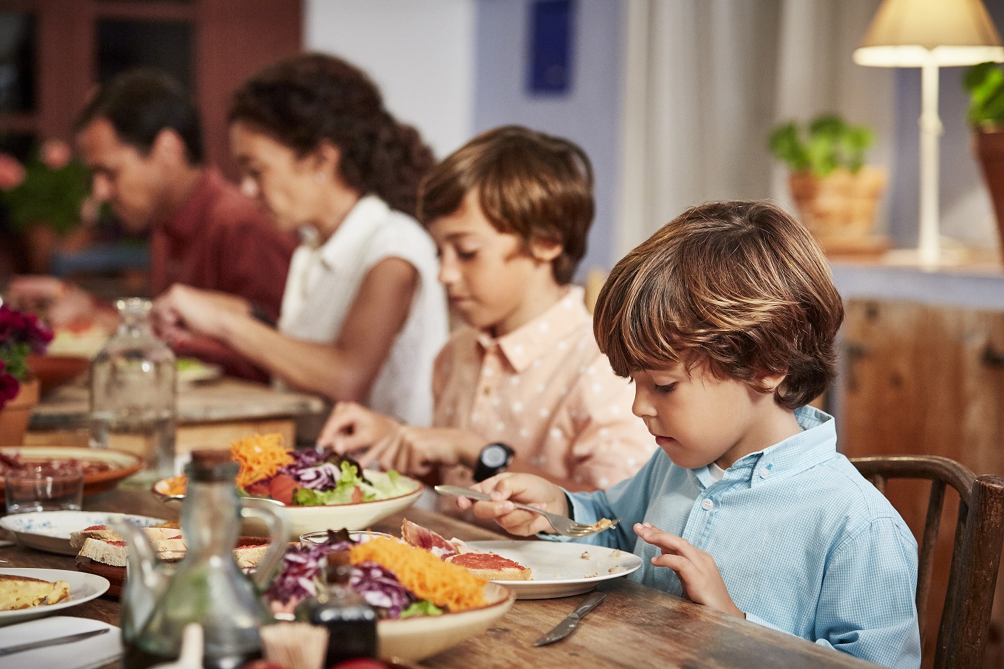 Family having food at table in dining room