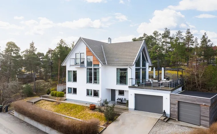 House with solar panels installed on the roof and outdoor patio furniture